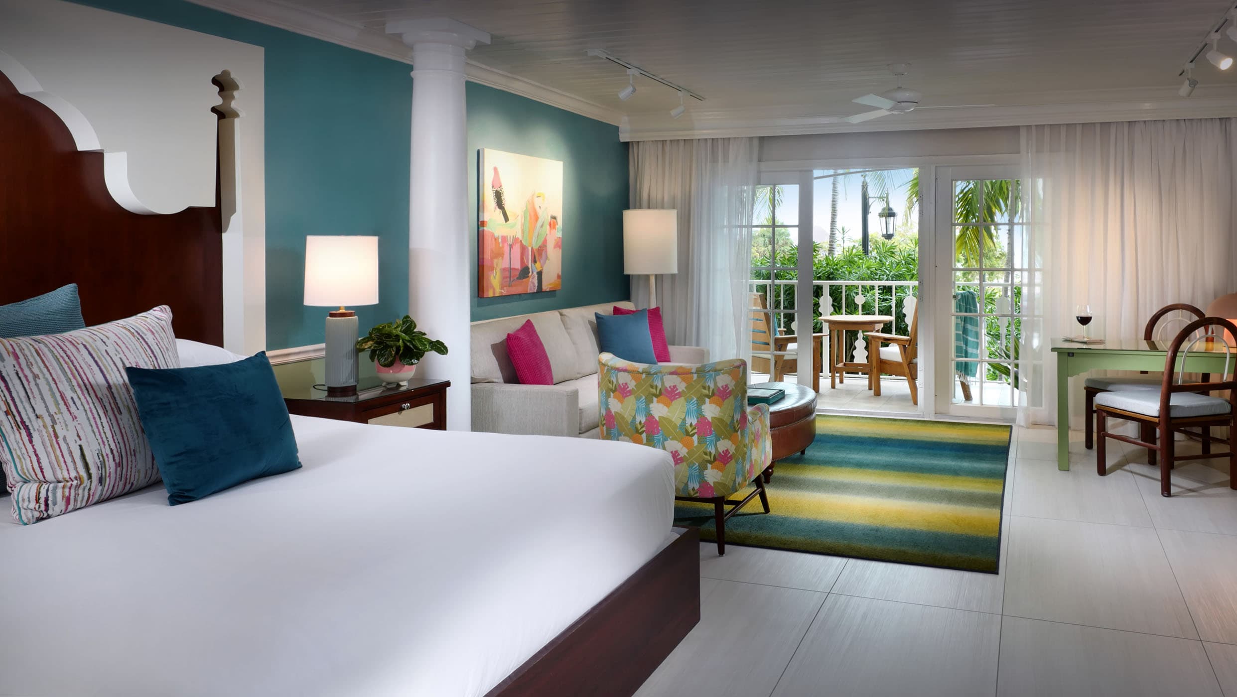 A Junior Suite with a living area, bed area, and access to a balcony at Ocean Key