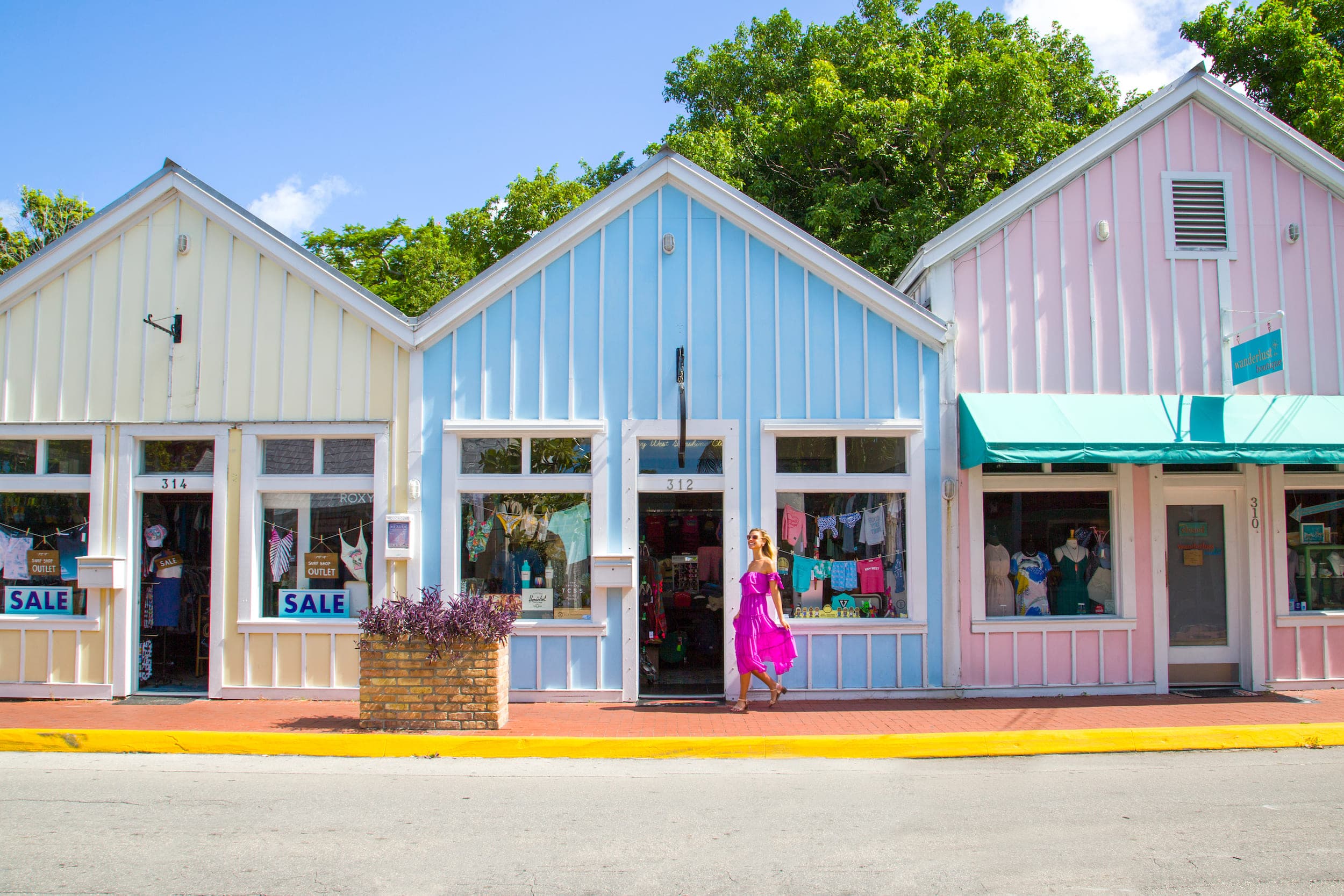 A row of brightly painted pastel "Conch" cottages.