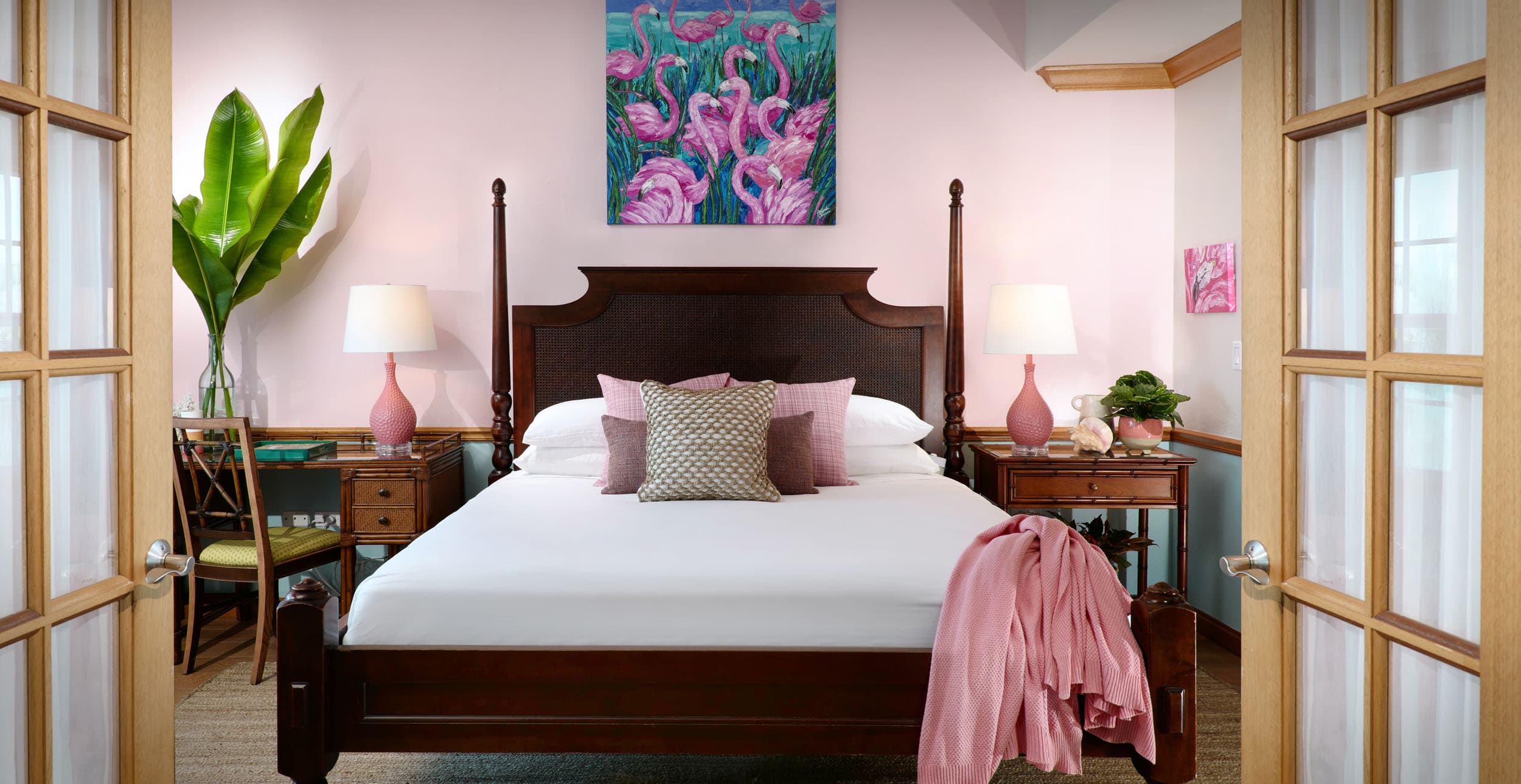 A queen bed area with a desk in a room at Ocean Key Resort