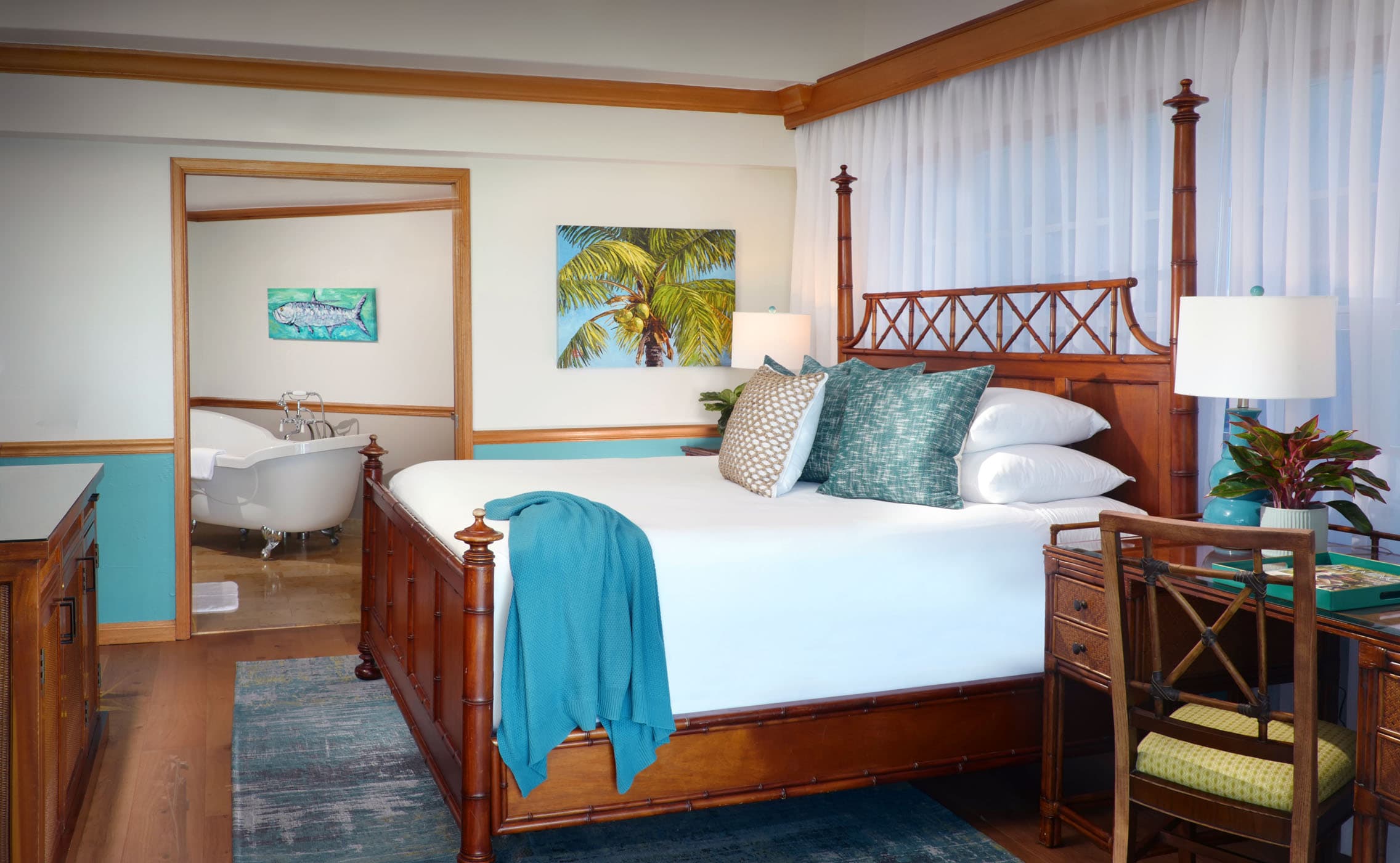 A king bed and desk in a suite at Ocean Key