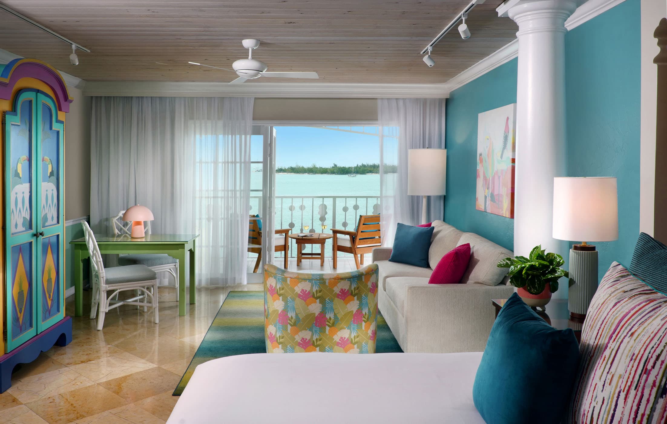 The bedroom, living room, and balcony overlooking the water in a Boutique Suite at Ocean Key