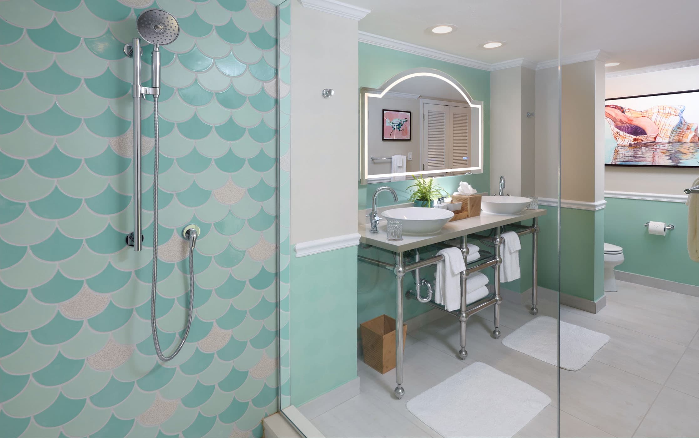 A shower and vanity area in a suite at Ocean Key