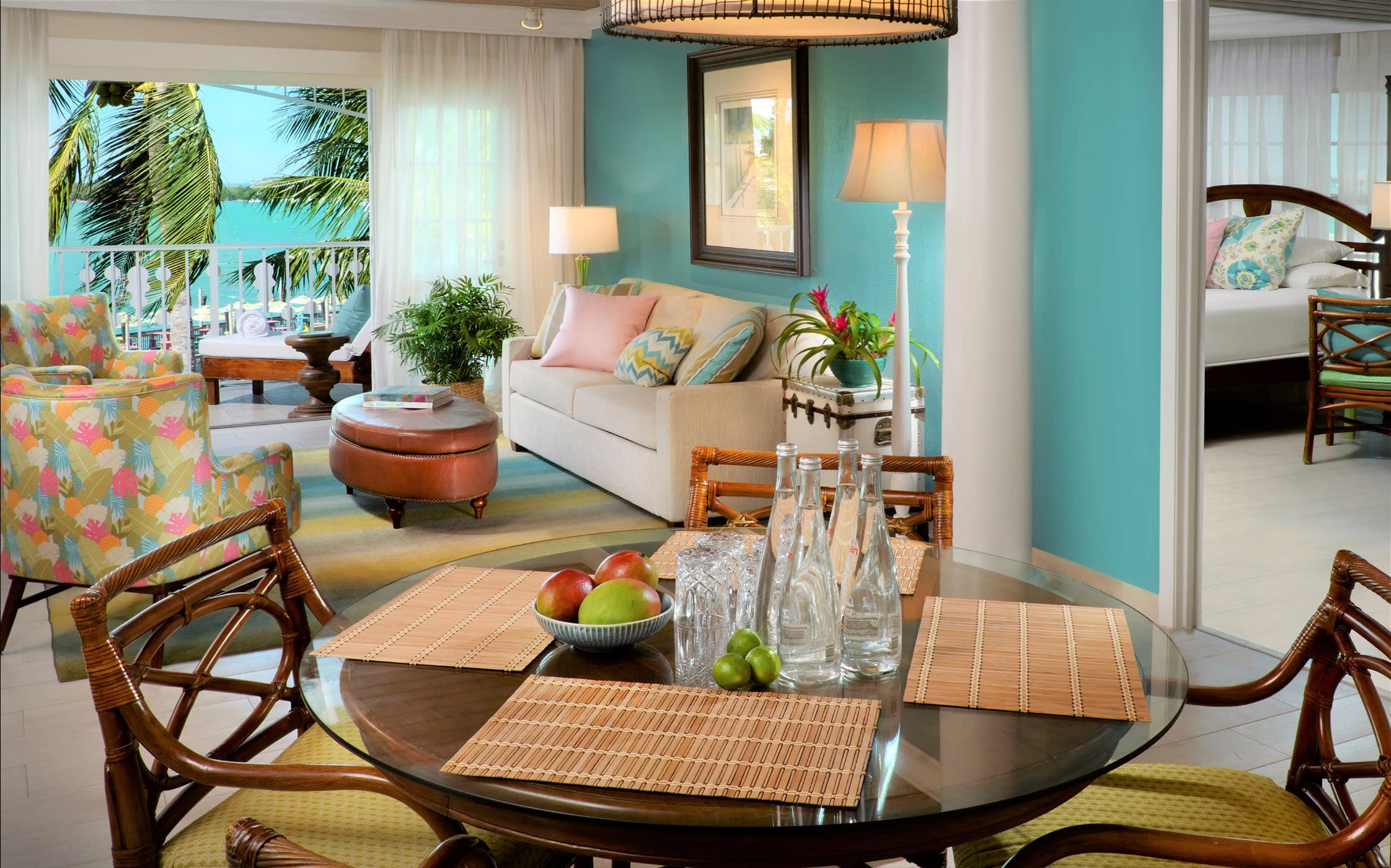 A 2 bedroom with a living space, dining table and access to the balcony at Ocean Key Resort