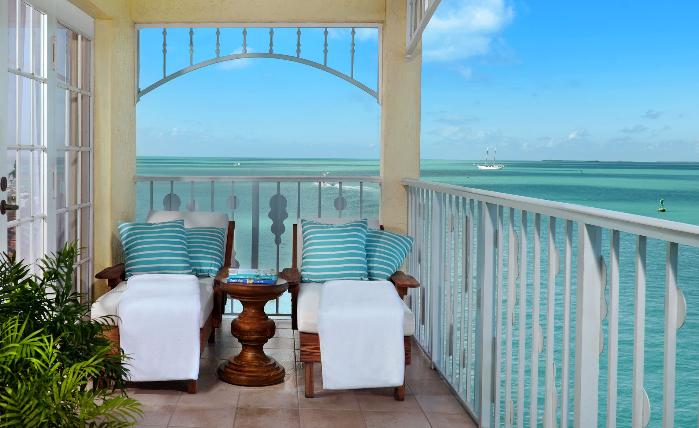 The presidential balcony with 2 lounge chairs and a view of the water