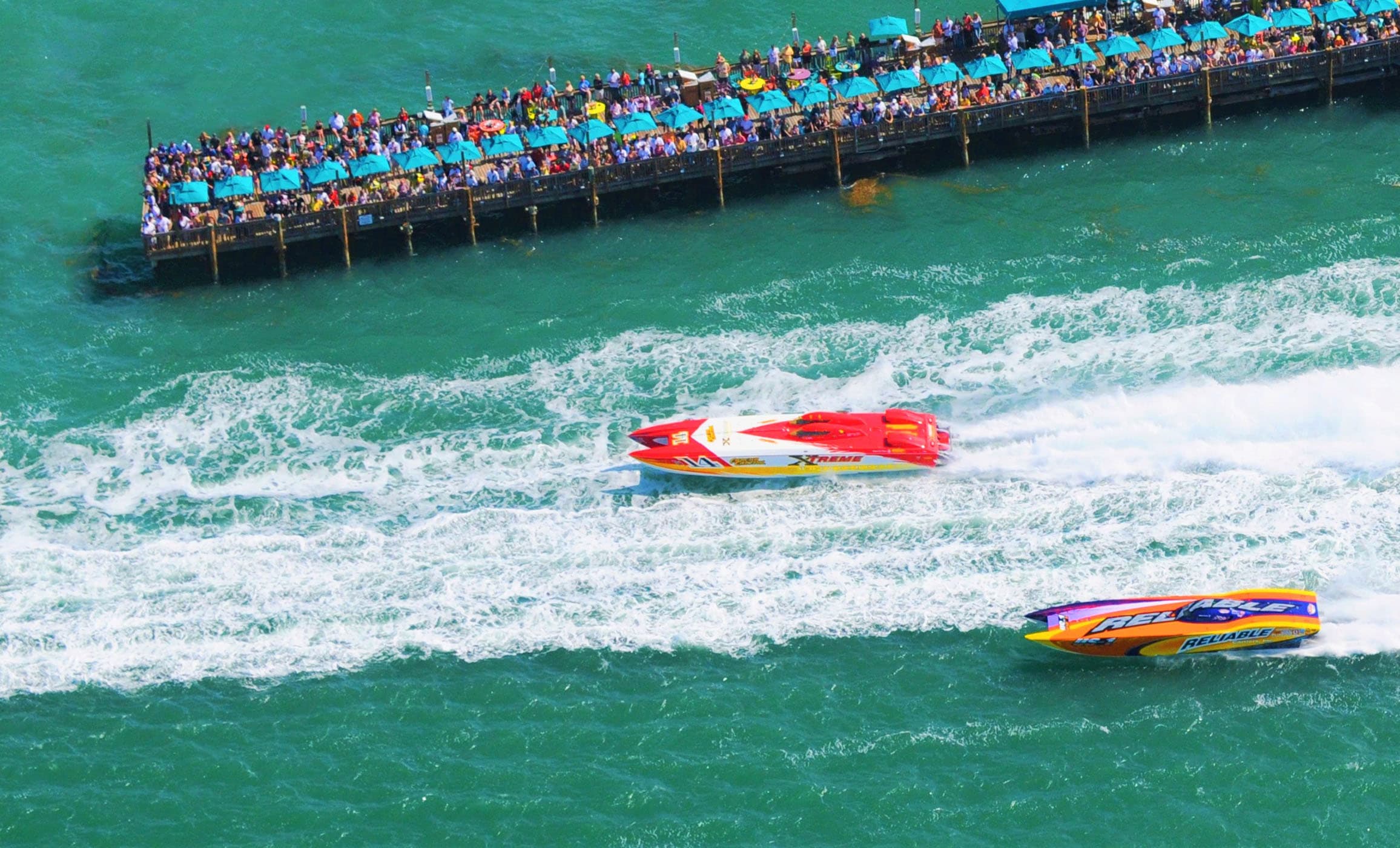 2 race boats racing near the pier at Ocean Ket Resort