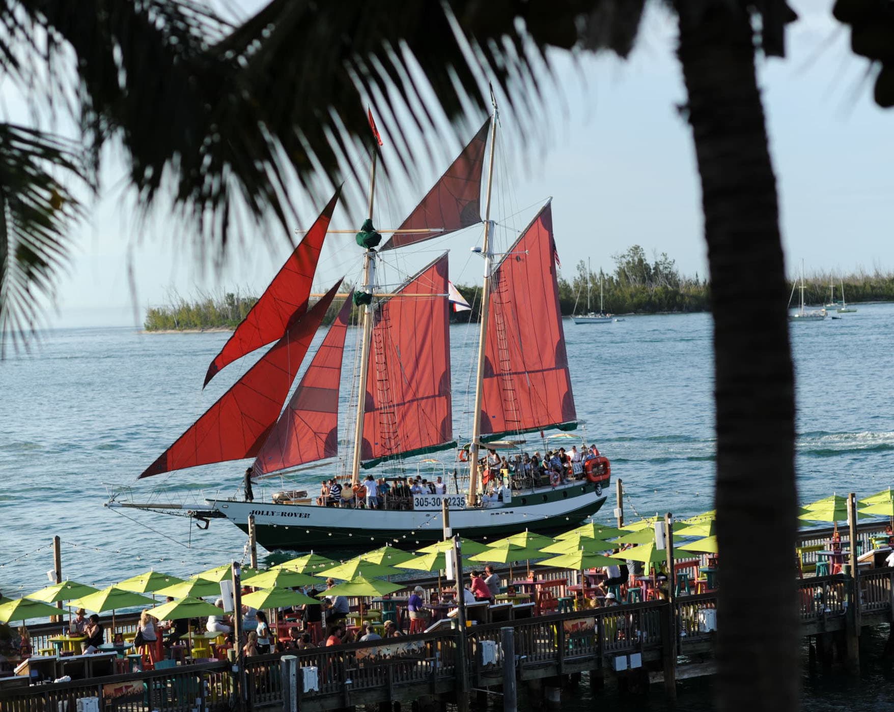 A large boat full of people bedside the pier at Ocean Key Resort