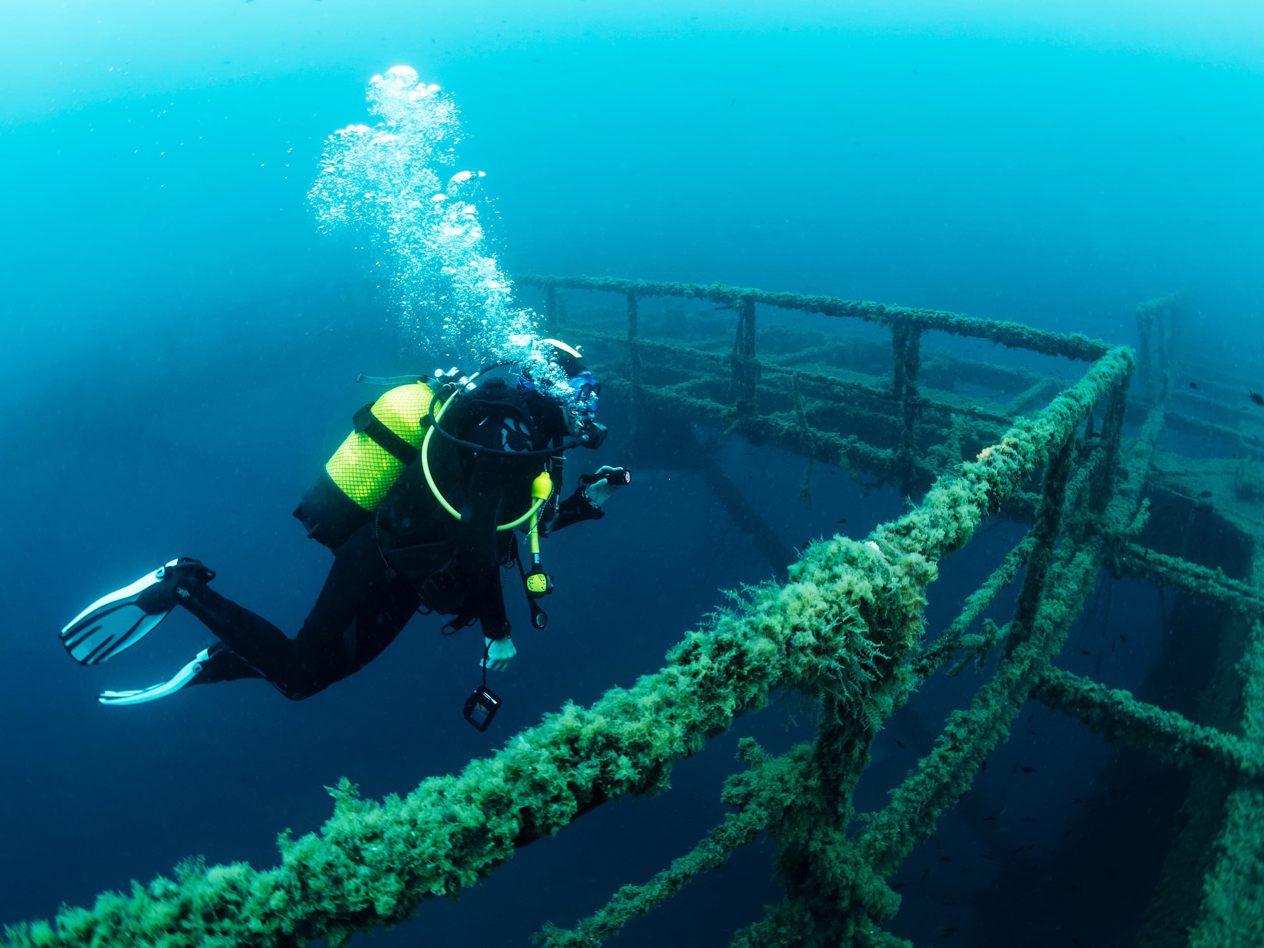 Diver Next To The Wreck Of A Structure Submerged