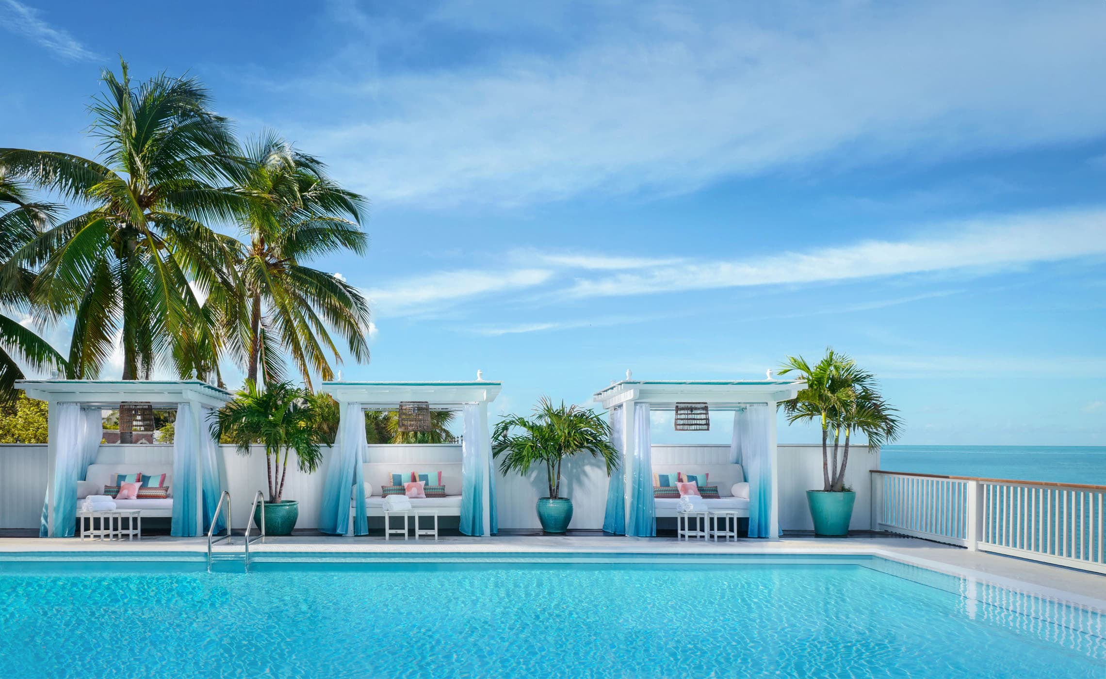 The pool with 3 cabanas and beautiful palm trees