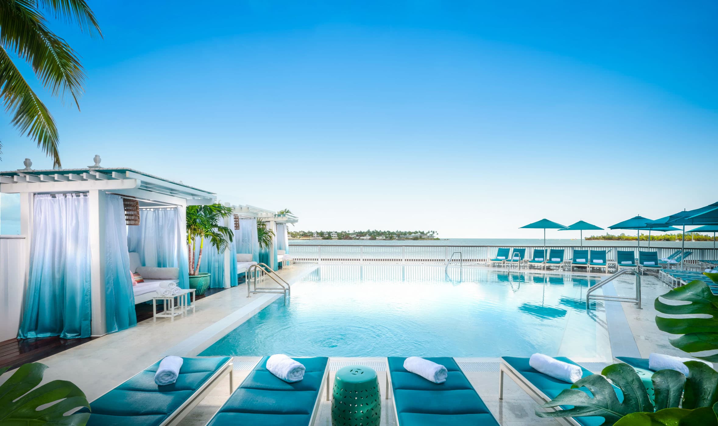 A stunning view of the pool with a clear blue sky at Ocean Key resort