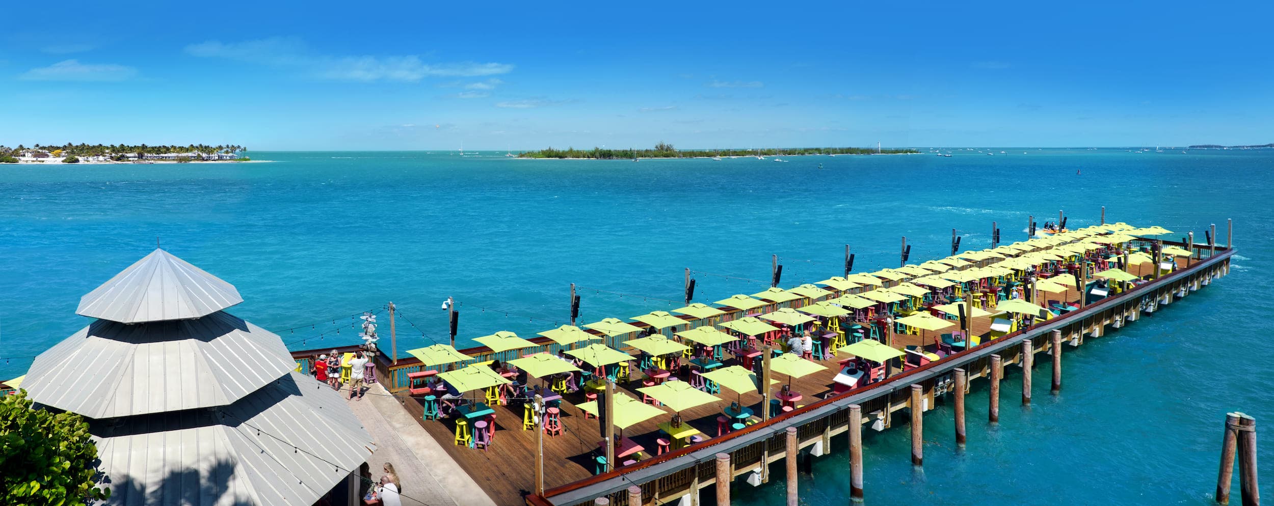 Sunset pier with tables and umbrellas