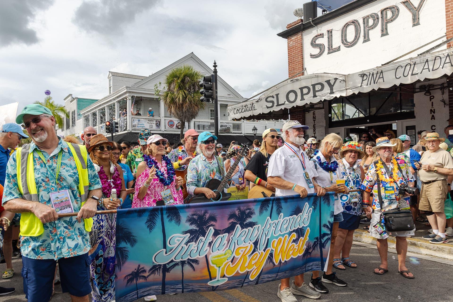 A gathering of people on the street for Just a Few Fiends Key West