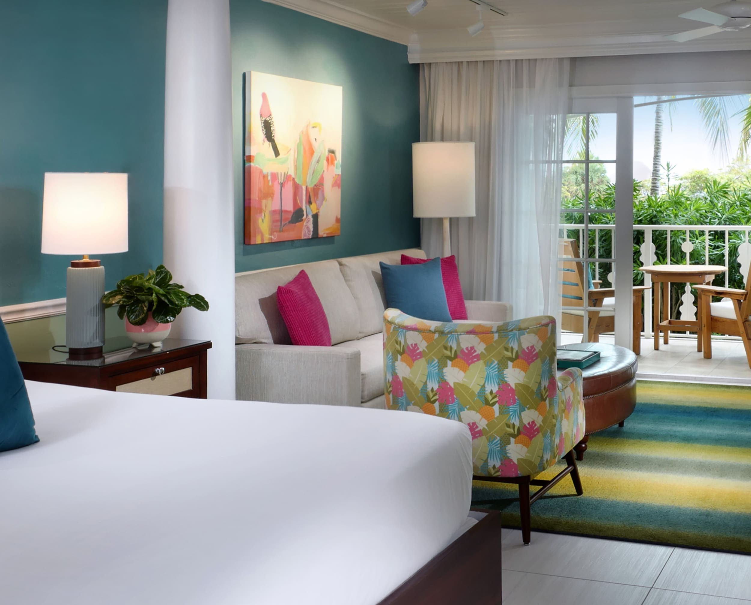 The bed, living space and balcony in a suite at Ocean Key Resort
