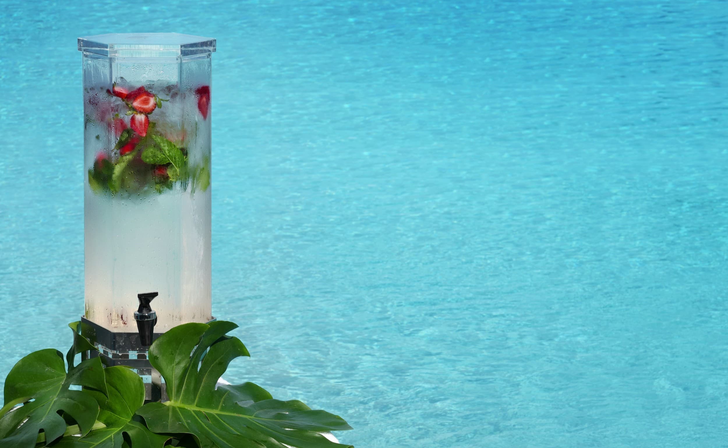 A glass water dispenser with fruit