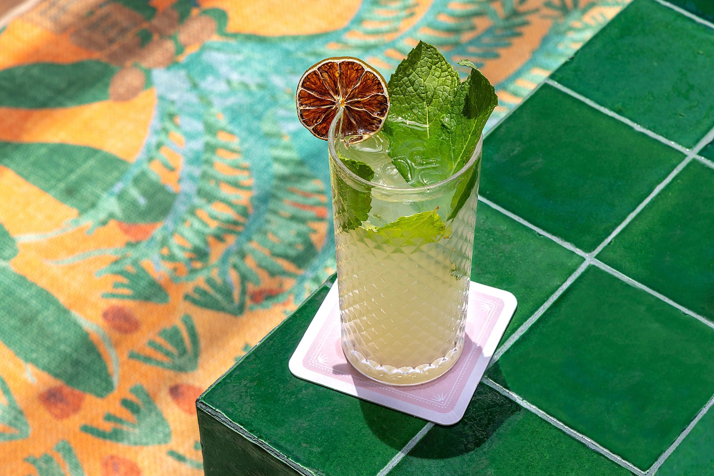 Refreshing mojito cocktail with mint and dried lime on green tile at Ocean Key Resort, Key West, Florida