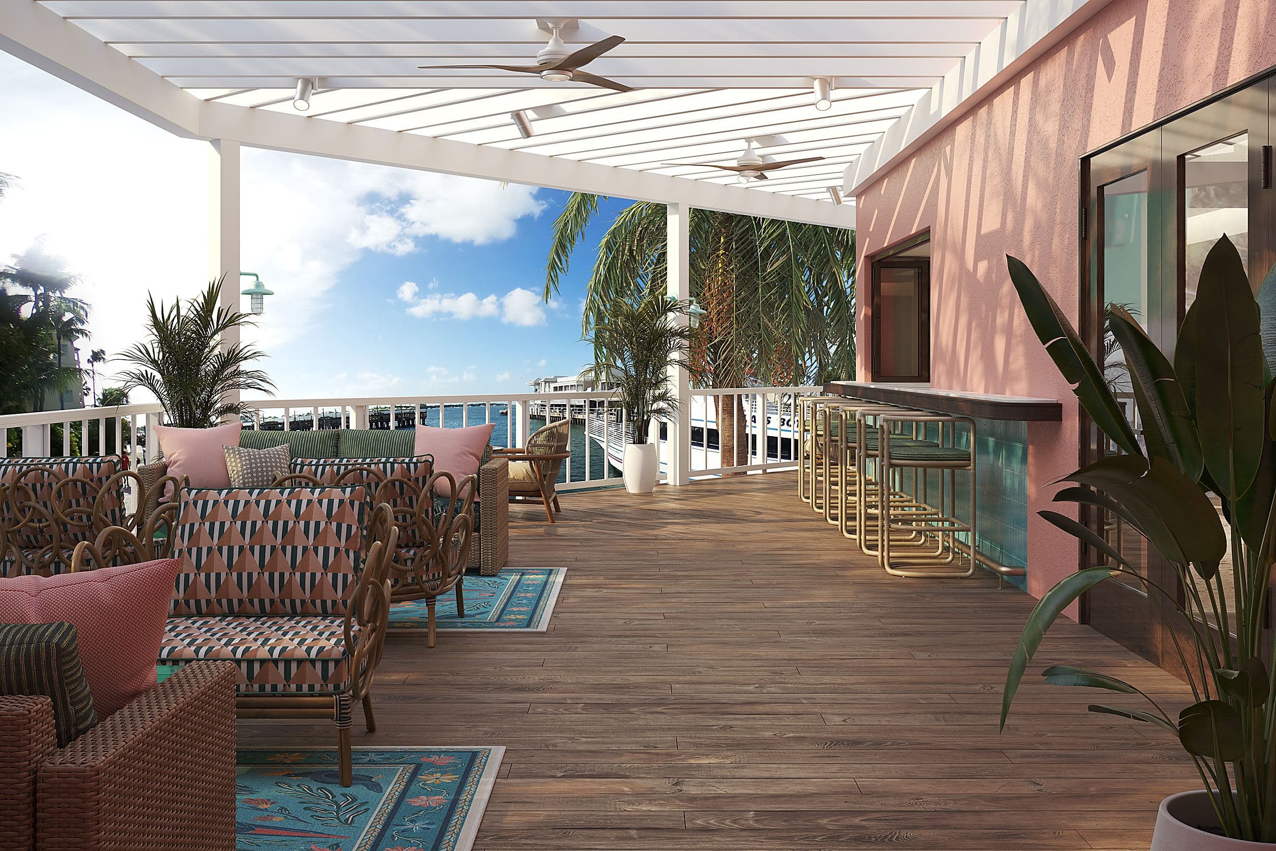 Waterfront covered deck lounge at Ocean Key Resort in Key West, Florida, with rattan seating, a pink stucco bar, and harbor views