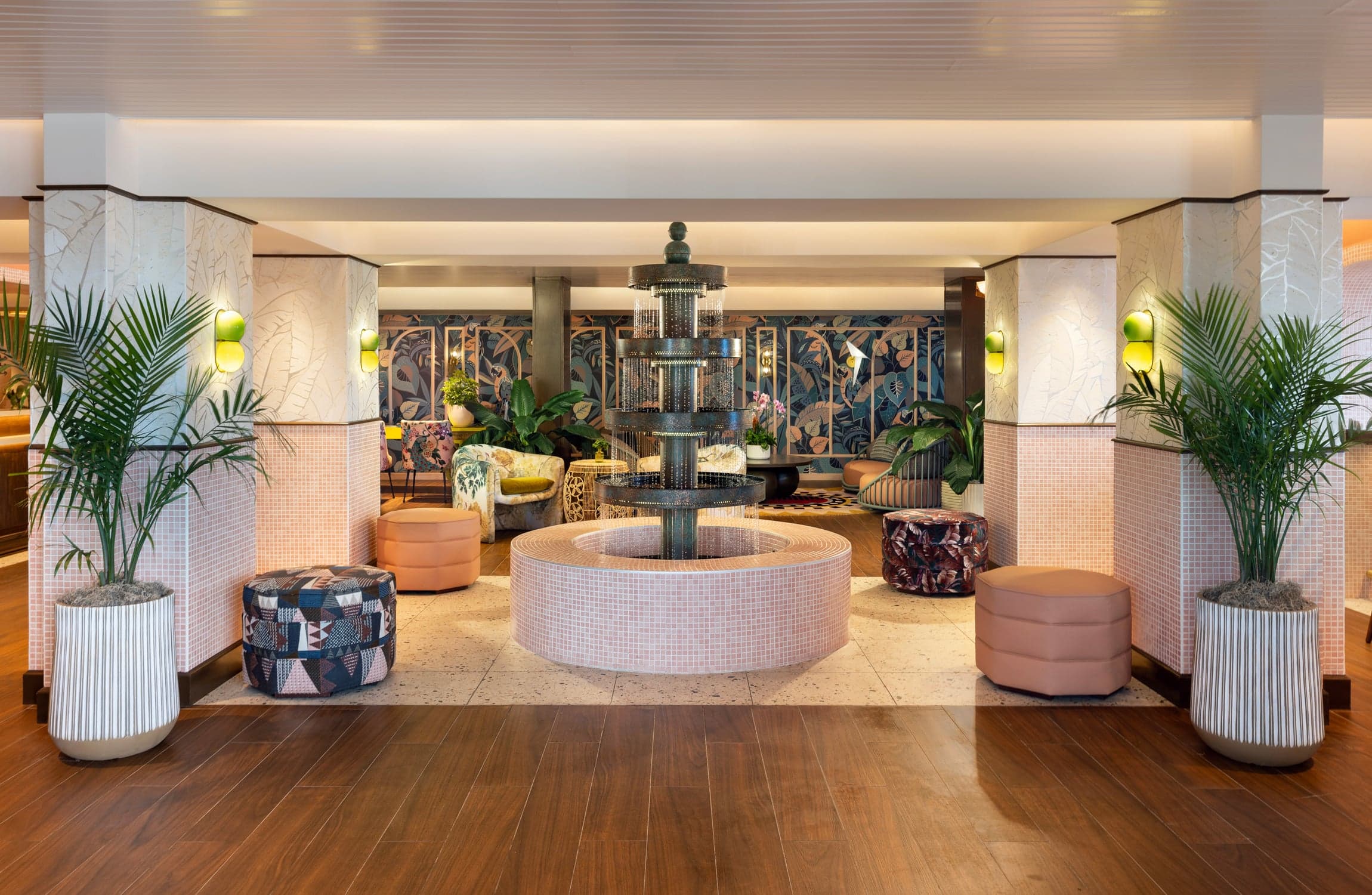 Elegant hotel lobby and lounge featuring potted palm trees, tiered tile fountain, and soft tropical decor at Ocean Key Resort, Key West, Florida