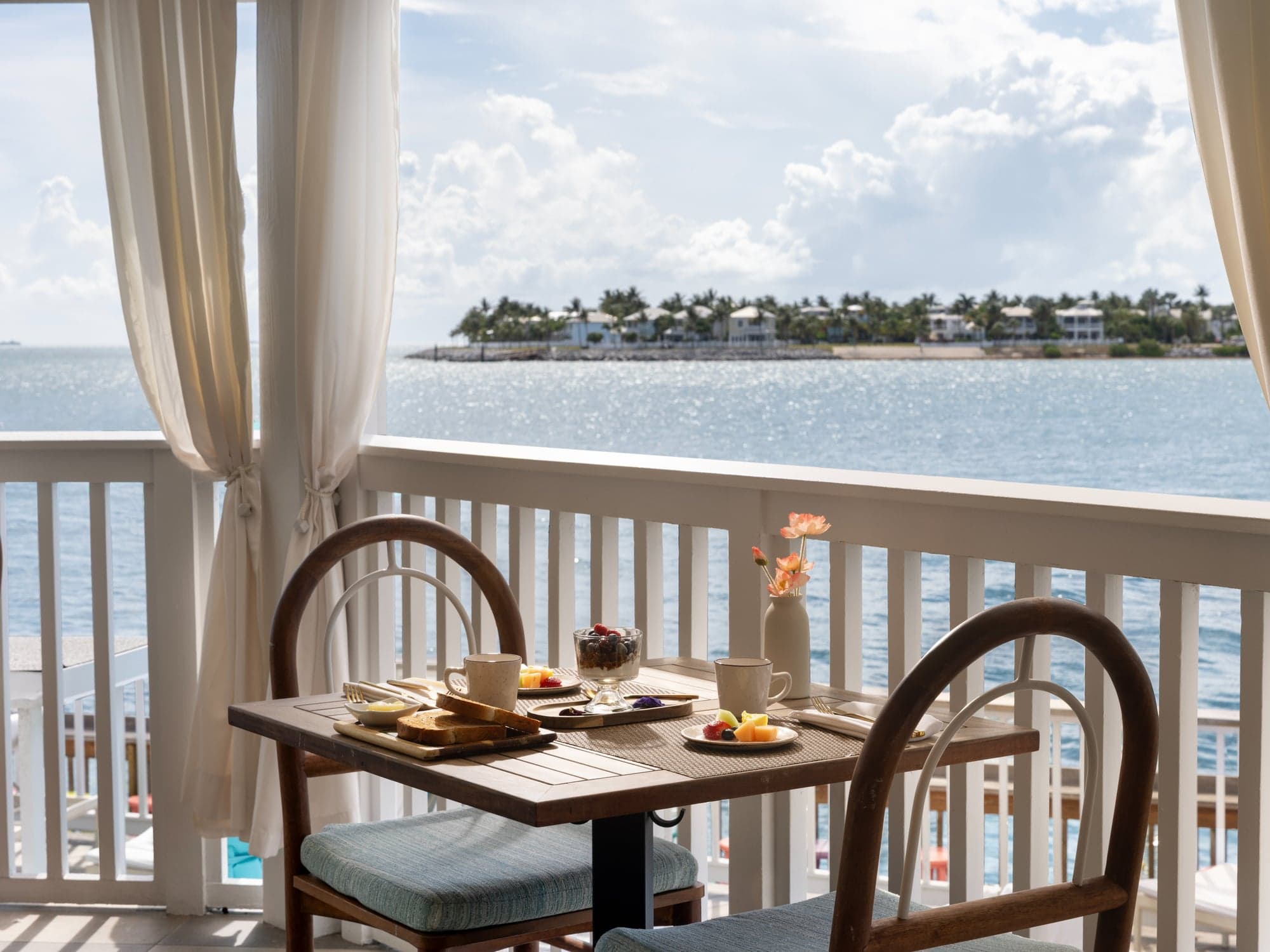 Breakfast for two on an oceanfront balcony at Ocean Key Resort overlooking the water and Sunset Key in Key West