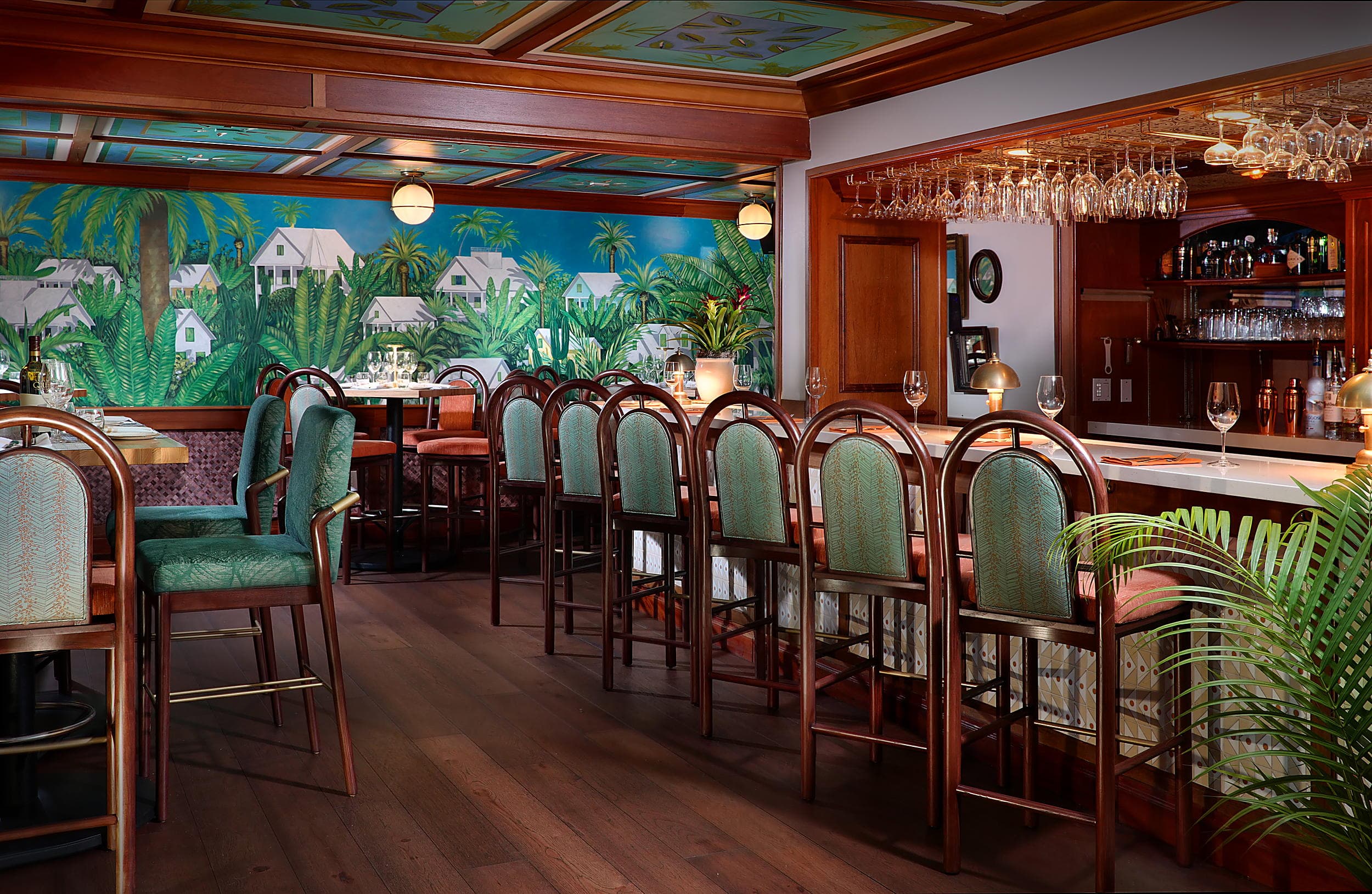 Hot Tin Roof bar with tropical mural and teal barstools at Ocean Key Resort in Key West, Florida