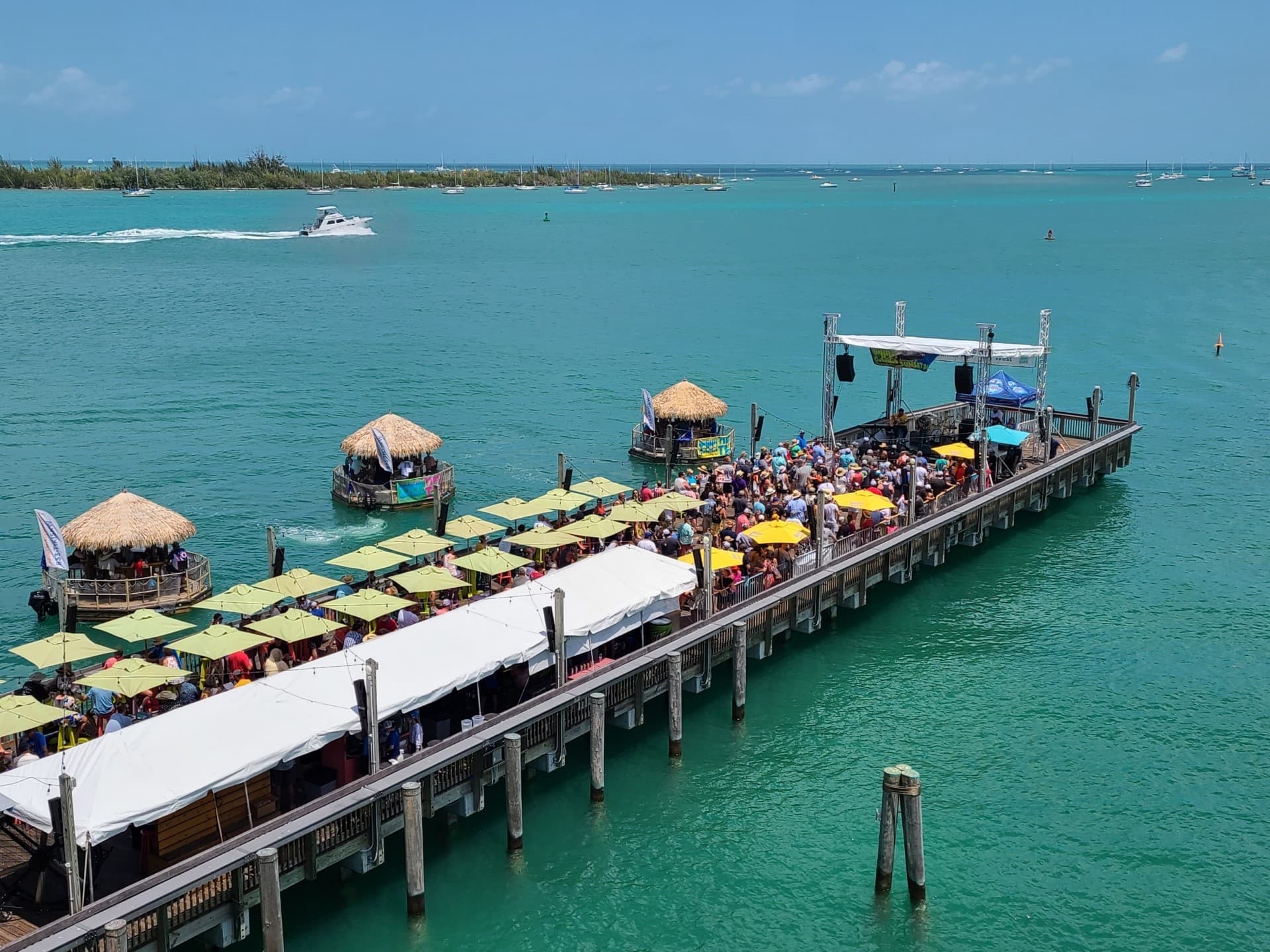 Sunset Pier stretching over turquoise water with floating tiki bars at Ocean Key Resort in Key West, Florida