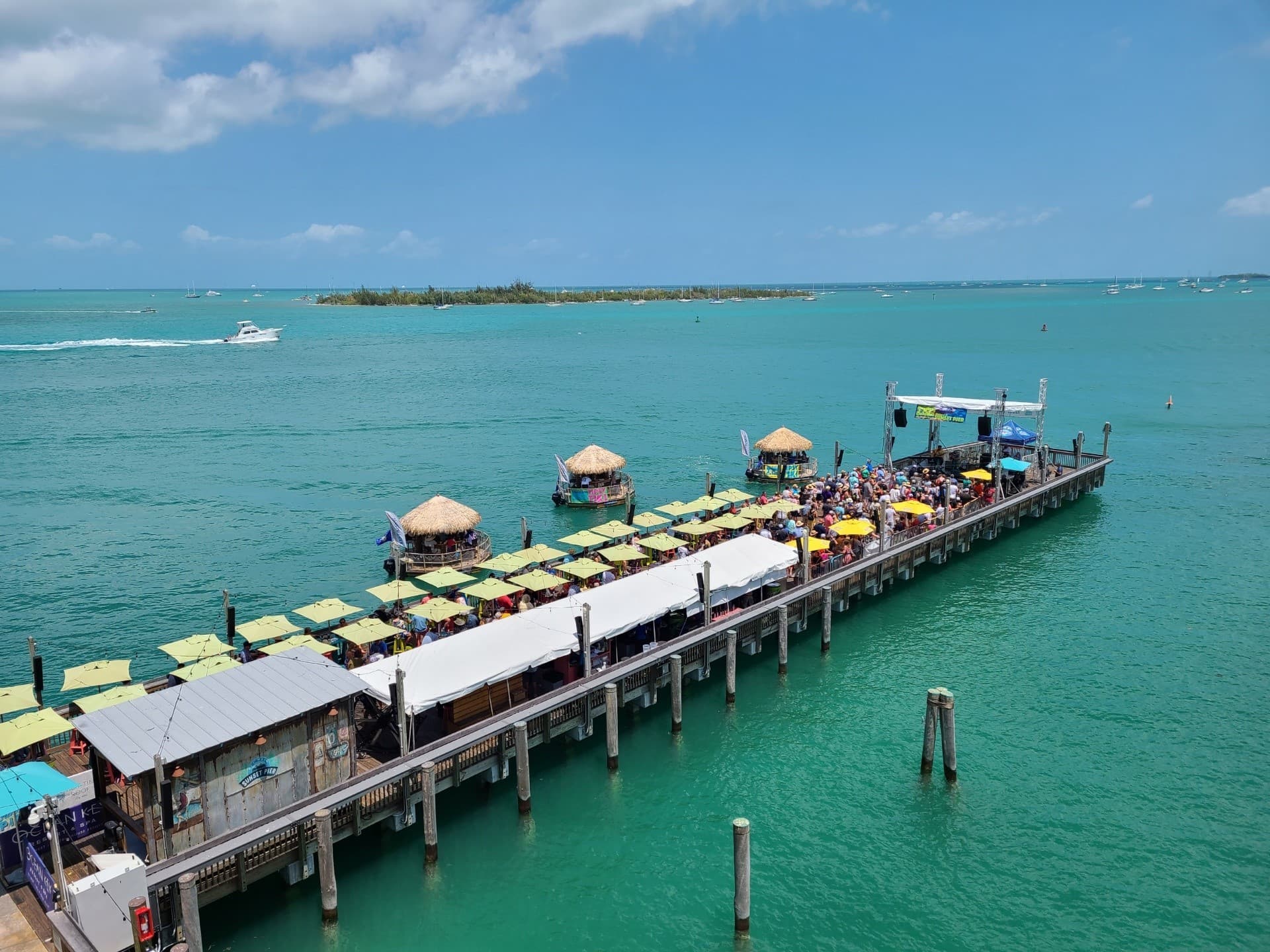 Crowd enjoying live music beside the Tipsy Tiki at Sunset Pier, Ocean Key Resort in Key West, Florida