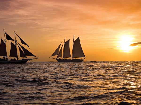 two sailboats at sunset