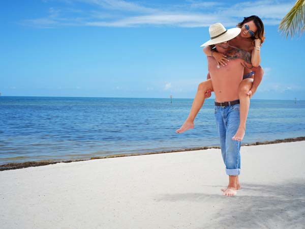 couple doing Piggy Back on the beach