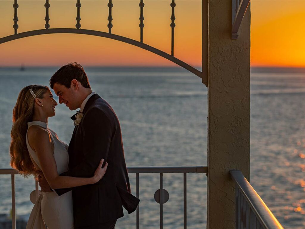 Bride And Groom In Front Of A Sunset.